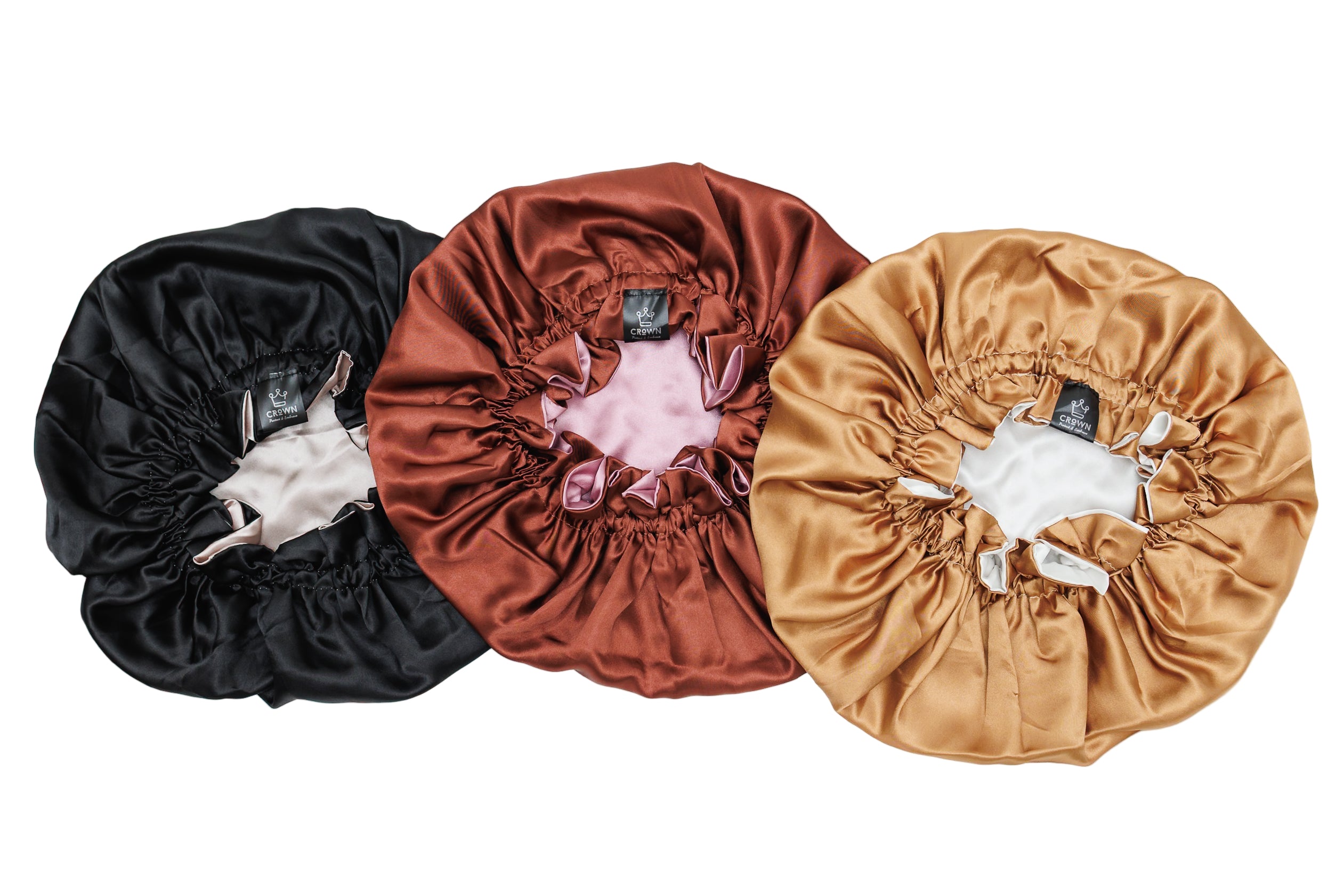 Three velvet hair bonnets in black, brown, and gold on a white background