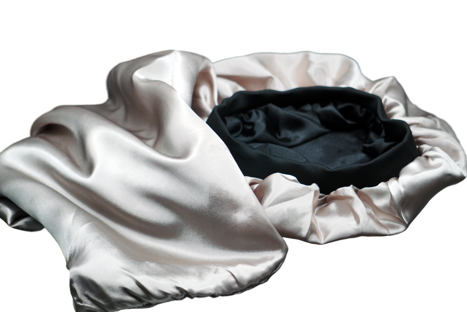 Black hat inside a beige garment bag on a dark surface