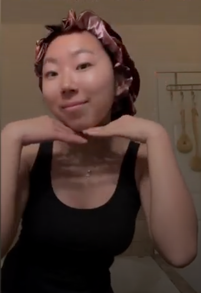 Woman with thick hair wearing a satin Bonnet indoors