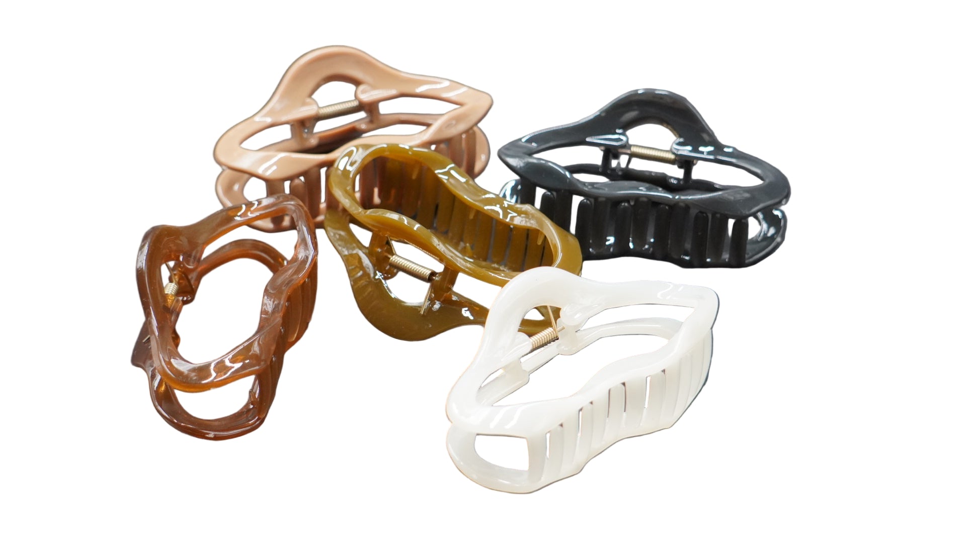 Set of five plastic clips in different colors on a gray background