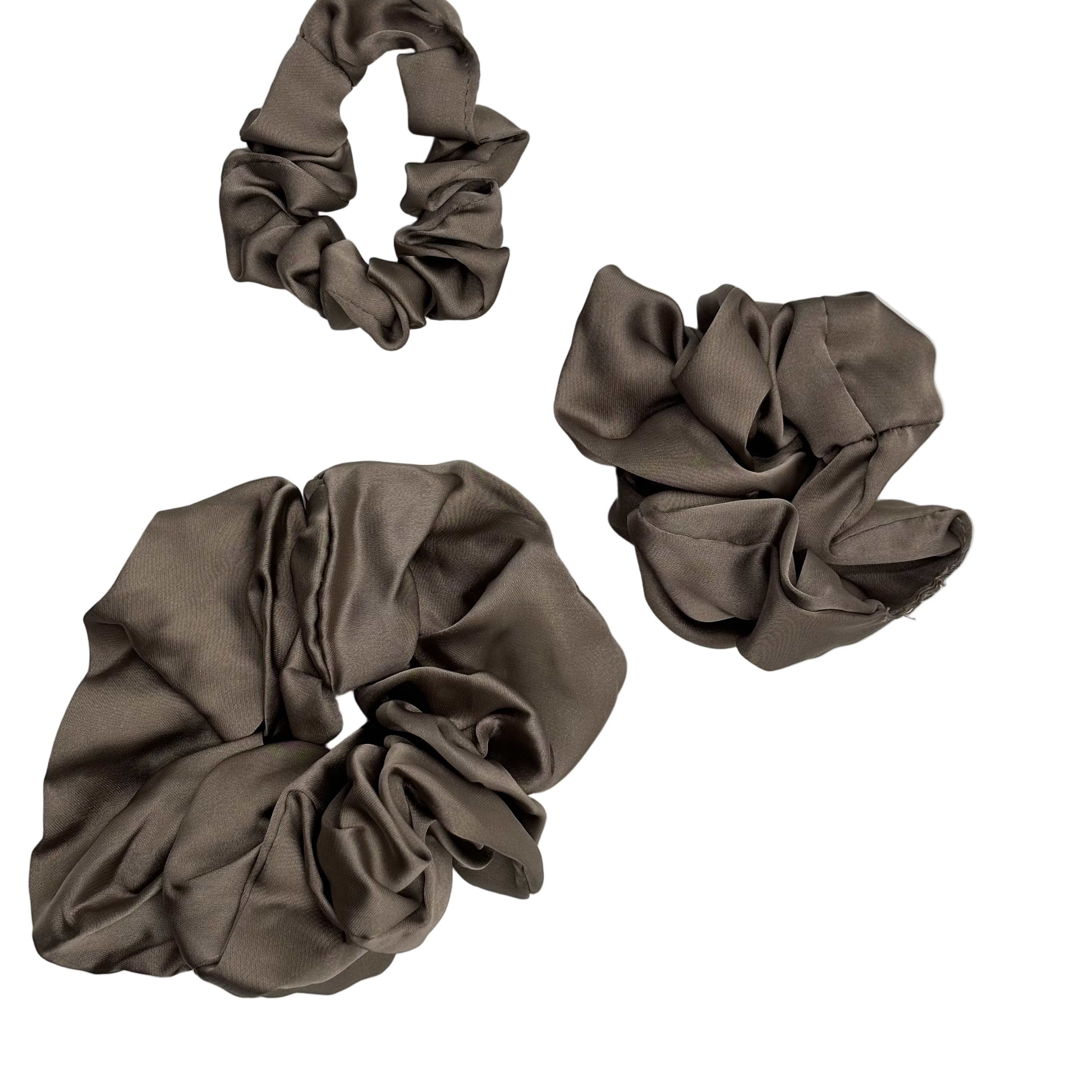 Three Cashmere color scrunchies on a light gray background