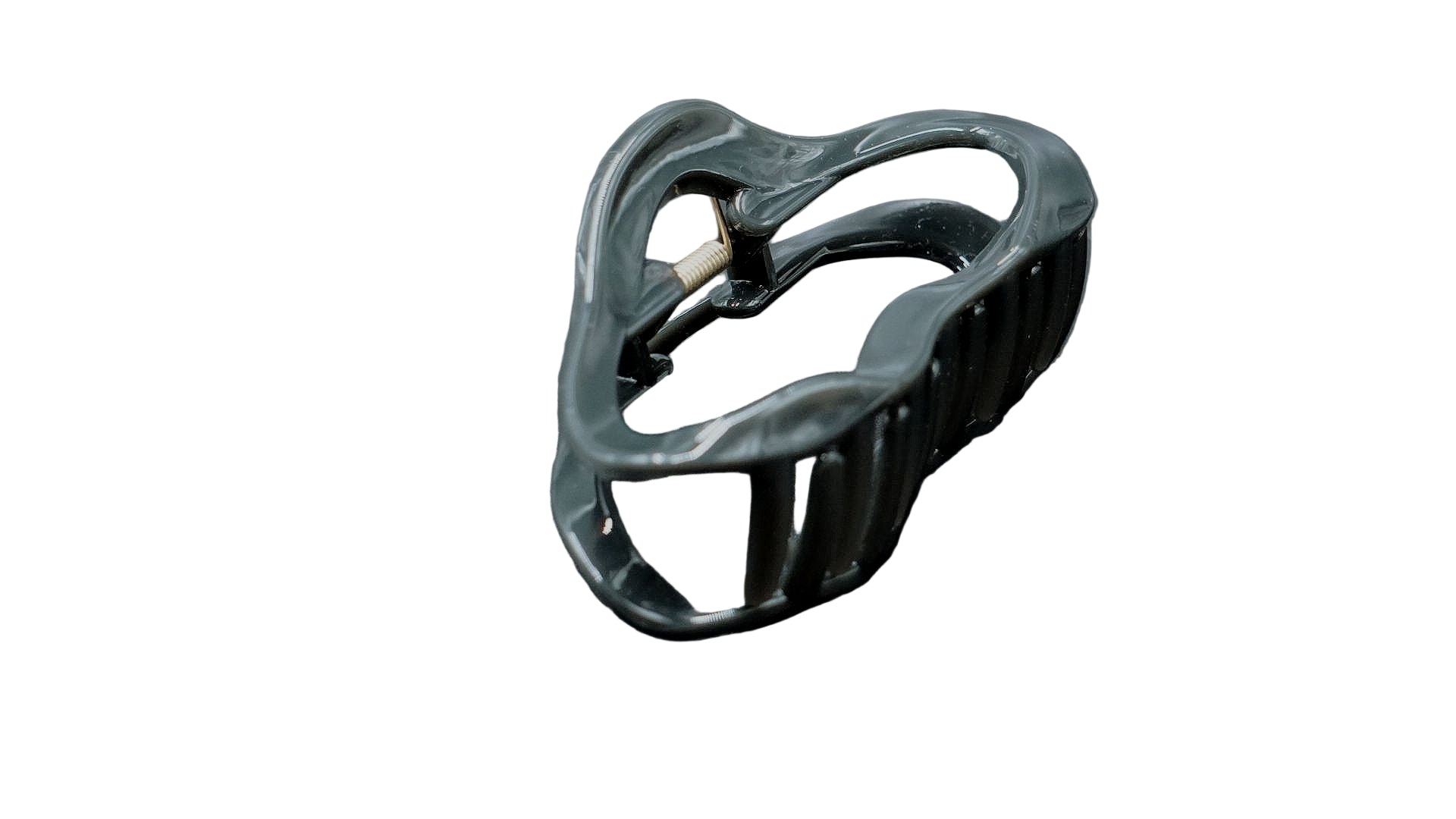 Black ceramic apple-shaped object on a dark gray background