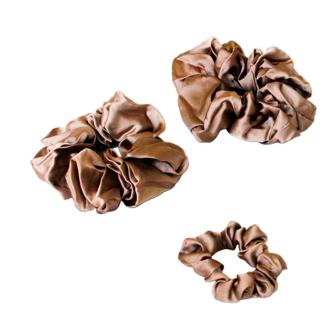 Three Golden scrunchies on a white background