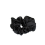 Black scrunchie on a beige background